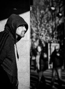 Street photography of a man donning a hoodie.