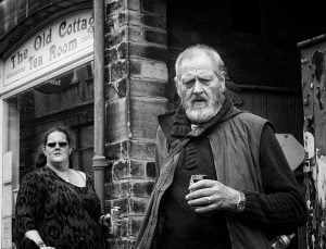 Street photography of a man and a woman strolling on a street.