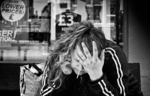 Street photography- A woman sitting on a bench.