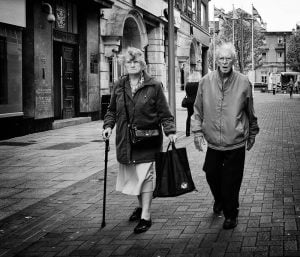 Street photography: Elderly couple walking.