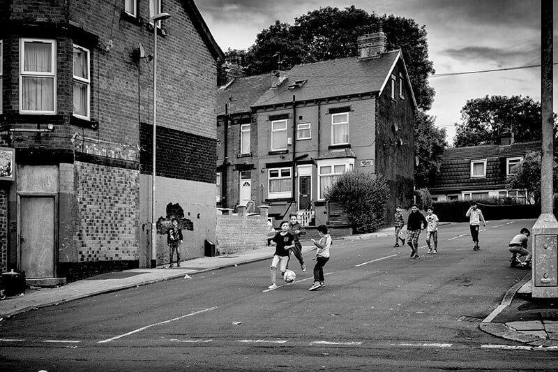 Black and white street photography of people walking.