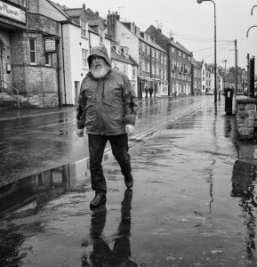 Street photography: A man walking down a street.