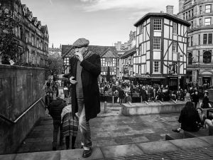 Black and white street photography of a man on a stairway.