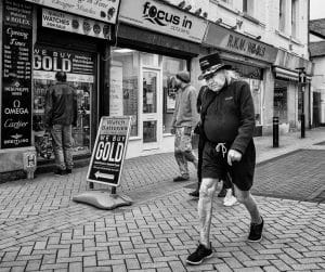 Monochrome street photography capturing the image of an elderly man strolling.