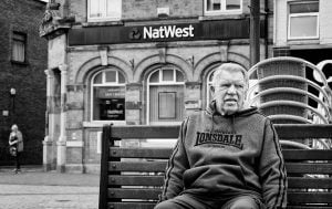 Street photography of a man on a bench.