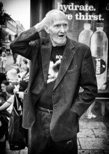 A street photography capture of an old man in black and white.