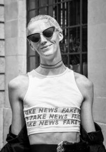 A monochrome image capturing a woman in shades and a midriff-baring top at Leeds Pride 2019.