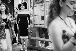 A woman in a black and white dress is photographed during Leeds Pride 2019.